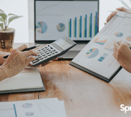 two people in a business meeting looking at charts and graphs to strategize for small business growth