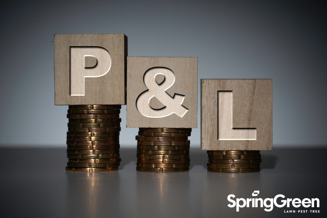 The letter P, the & sign and the letter L are sitting on top of coins. The P stands for profit and has the most amount of coins and it goes descending with the &, and the L on top of the lowest amount of coins.